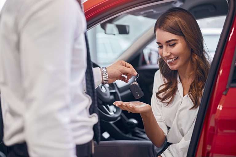 Exchange of car keys in a dealership representing the purchase of a car, falling in the customer loyalty section of the sales process. For RTS Academy.