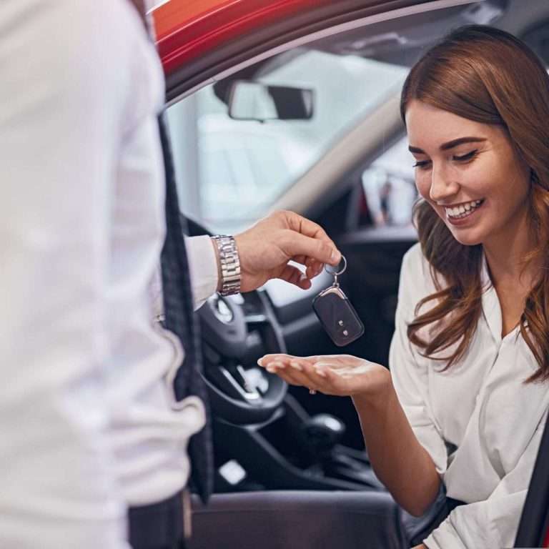 Exchange of car keys in a dealership representing the purchase of a car, falling in the customer loyalty section of the sales process. For RTS Academy.