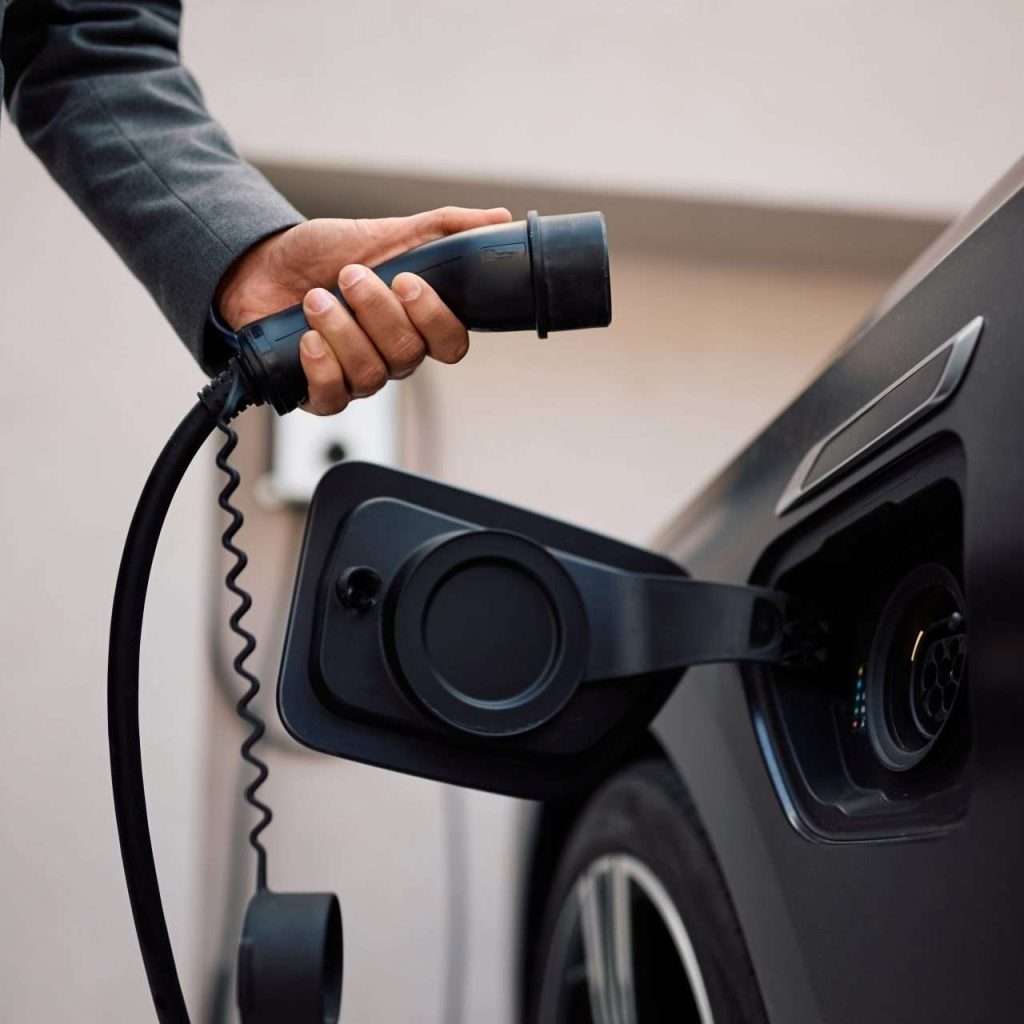 A person about to plug in an electric vehicle and start charging it for the image to the RTS Academy "The EV Landscape" eLearning course.